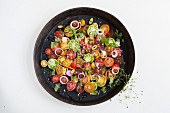An heirloom tomato salad with onion rings and herbs