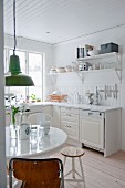 Dining area in white country-house kitchen