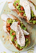 Chicken and avocado on slices of toasted baguette