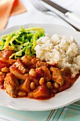 Slow cooked pork and bean stew with mashed potatoes