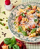 Fusili pasta with tomatoes, basil and grated cheese