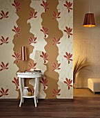 Wall decorated with cut-out sections of floral wallpaper over beige paint