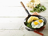 Fried eggs with spinach and potatoes