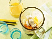 Ingredients for a banana and carrot smoothie in a blender