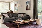 Rustic coffee table in front of dark grey sofa in living room