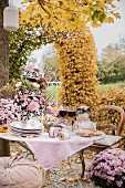 Romantisch gedeckter Tisch im Herbstgarten