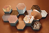 Fabric patterns on honeycomb-shaped objects in shades of nickel, copper and brass