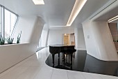 Grand piano on curved, glossy black floor area in futuristic white room