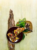 Chestnuts and black chanterelles with tomatoes on grilled bread