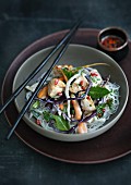 Chicken with cabbage and peppermint on rice noodles
