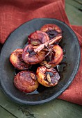Oven-baked plums in a spiced red wine sauce