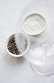 Coarsely ground pepper and salt in white dishes