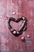 A chocolate heart with dried rose buds