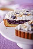 Blueberry tart with meringue, sliced