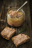 Goose liver pâté in a jar and on slices of bread