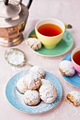 Almond biscuits with icing sugar served with tea