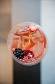 A summer drink with berries and ice cubes (seen from above)