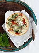 Malfatti (Italian spinach dumplings) with cheese and tomato sauce