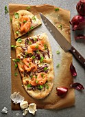 Sour cream pizza with smoked salmon, onions and cress