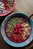 Acai smoothie in bowls with various toppings