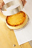 A ring being removed from a cheesecake