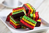 Colourful rainbow biscuits made with almond paste and chocolate glaze