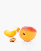 Apricots, an apricot wedge and an apricot stone