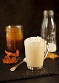 Caramel latte topped with whipped cream and nutmeg