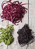 Green pasta with spinach, red pasta with beetroot and black pasta with squid ink