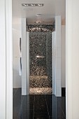 Floor-level separate shower area with mosaic tiles in designer bathroom