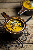 Pumpkin soup with flaked almonds, chilli threads and pumpkin seed oil