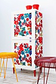 Wardrobe revamped with floral fabric, decorative knobs and red legs