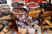 Various types of ham at a market in Ajaccio (Corsica)