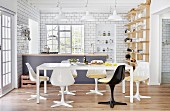 Retro shell chairs around white table in open-plan kitchen with counter and white-tiled walls
