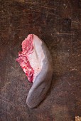 A beef tongue on a wooden board