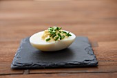 A devilled egg with chives