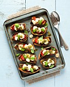 Potato skins filled with roasted tomatoes, goats cheese and pesto