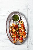 Prawn skewers with cherry tomatoes, bread and a basil sauce