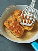 Breaded fish fillet in a pan