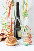 Doughnuts and sparkling wine decorated with paper streamers