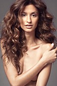 A naked woman with long curly hair