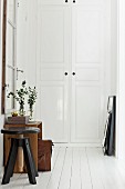 White wooden floor and swivel stool in vintage-style hallway