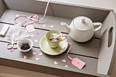 Tea set and hand-made teabags on tray