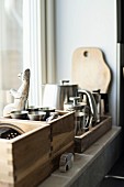 Wooden crates of kitchen utensils on windowsill