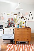 Retro chest of drawers and collage in workspace