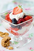 Berry dessert with ice cream and whipped cream