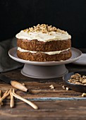 Carrot cake with a cream cheese frosting and chopped walnuts