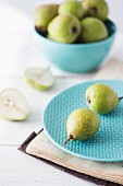 Fresh ripe pears on a plate and in a bowl