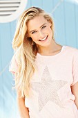 Junge blonde Frau in T-Shirt mit Sternmotiv