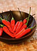 Red chilli peppers in a wooden bowl